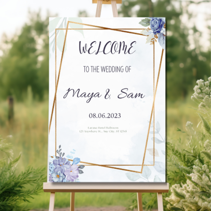 Personalized wedding welcome sign with floral accents and gold geometric frame on an easel.