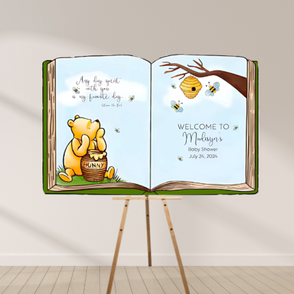 Winnie the Pooh storybook baby shower backdrop with Pooh Bear, honey pot, and bees – custom open book party sign.