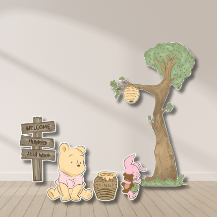 Winnie the Pooh and Piglet cutout decorations with honey tree and Hundred Acre Wood sign for baby shower and birthday parties.