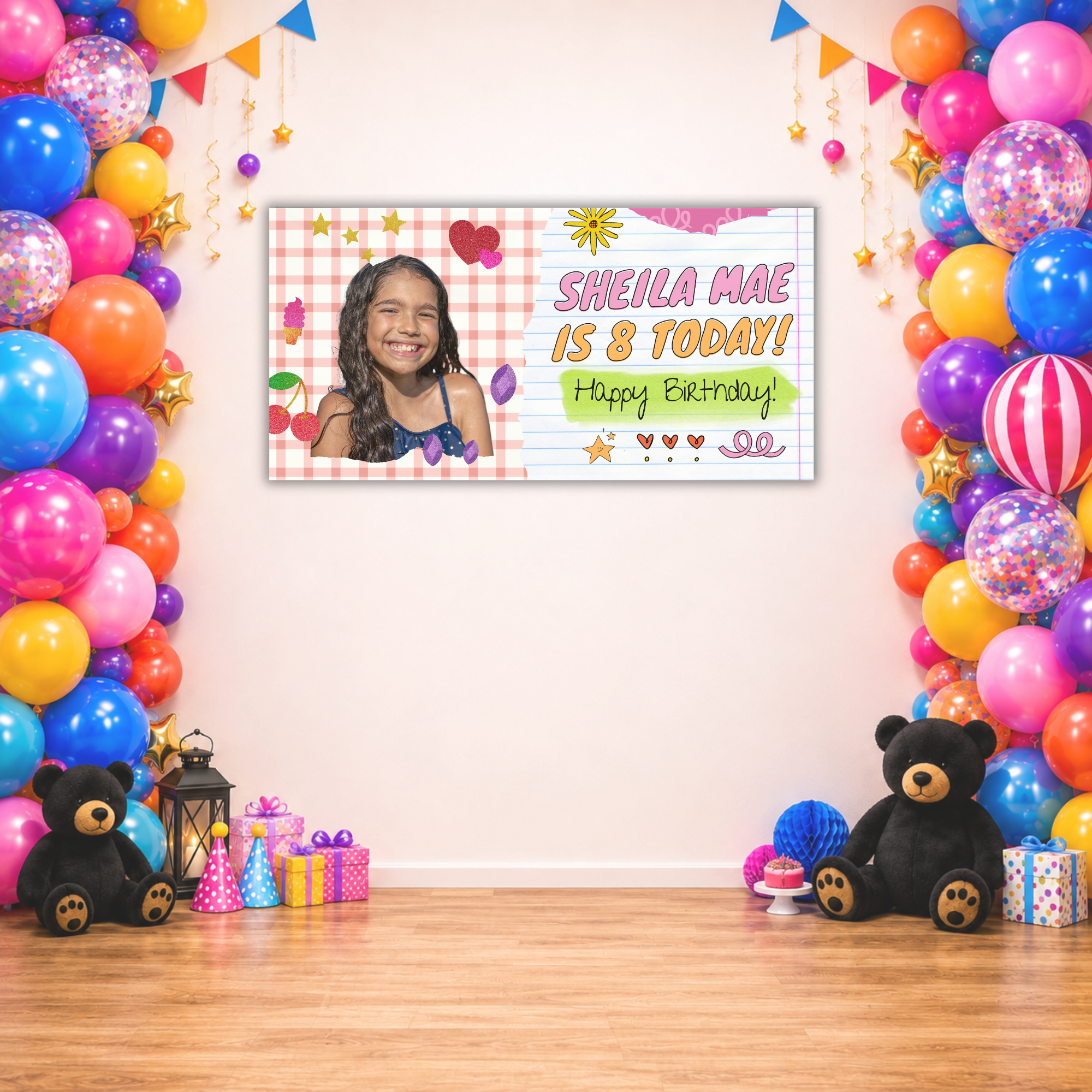 Custom girls photo birthday banner displayed between colorful balloon garlands and party decorations