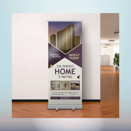 Custom retractable banner stand displaying real estate advertising in a professional indoor setting.
