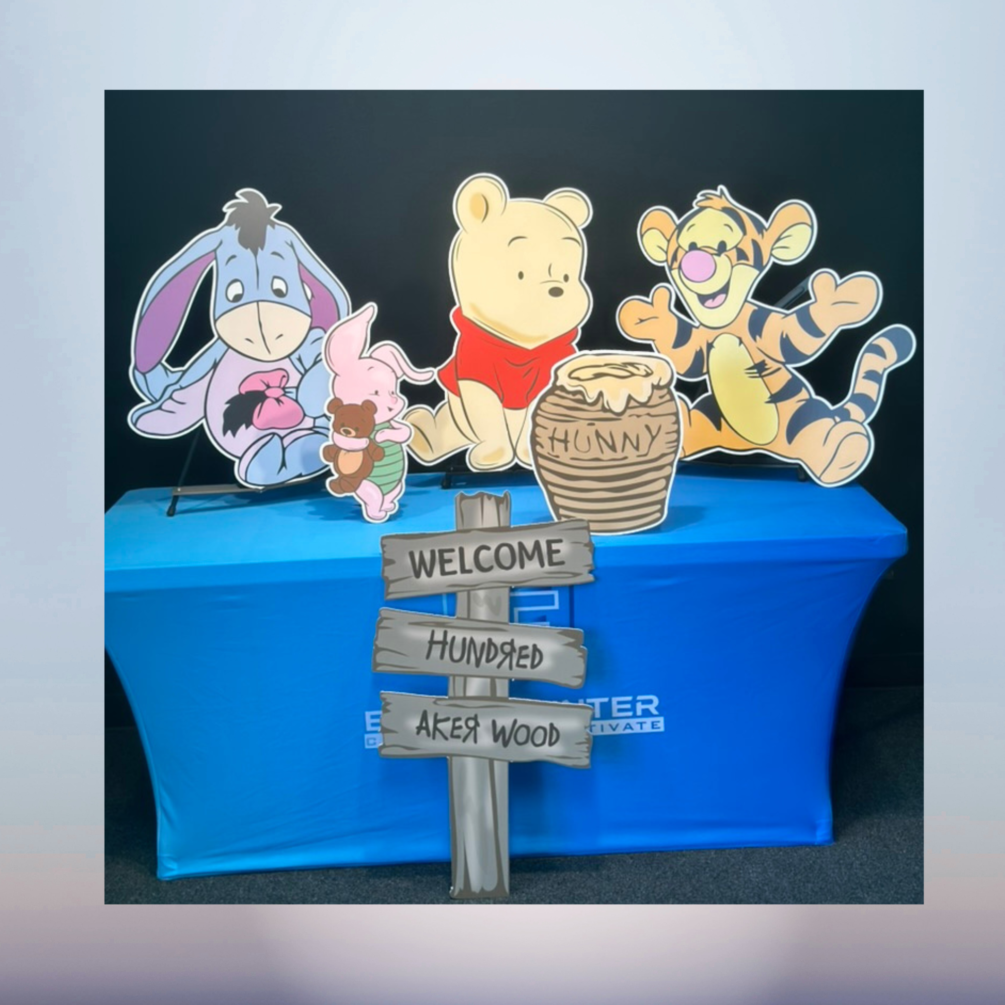 Winnie the Pooh character cutout set with Hundred Acre Wood welcome sign