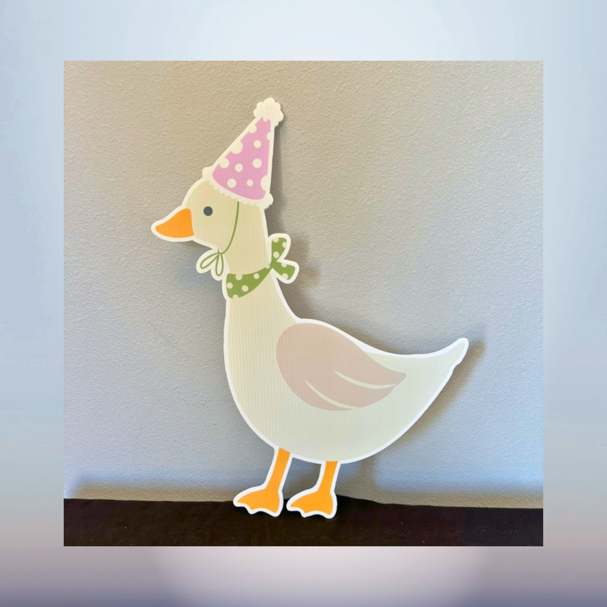 Cute goose character cutout wearing a pink party hat for baby shower décor