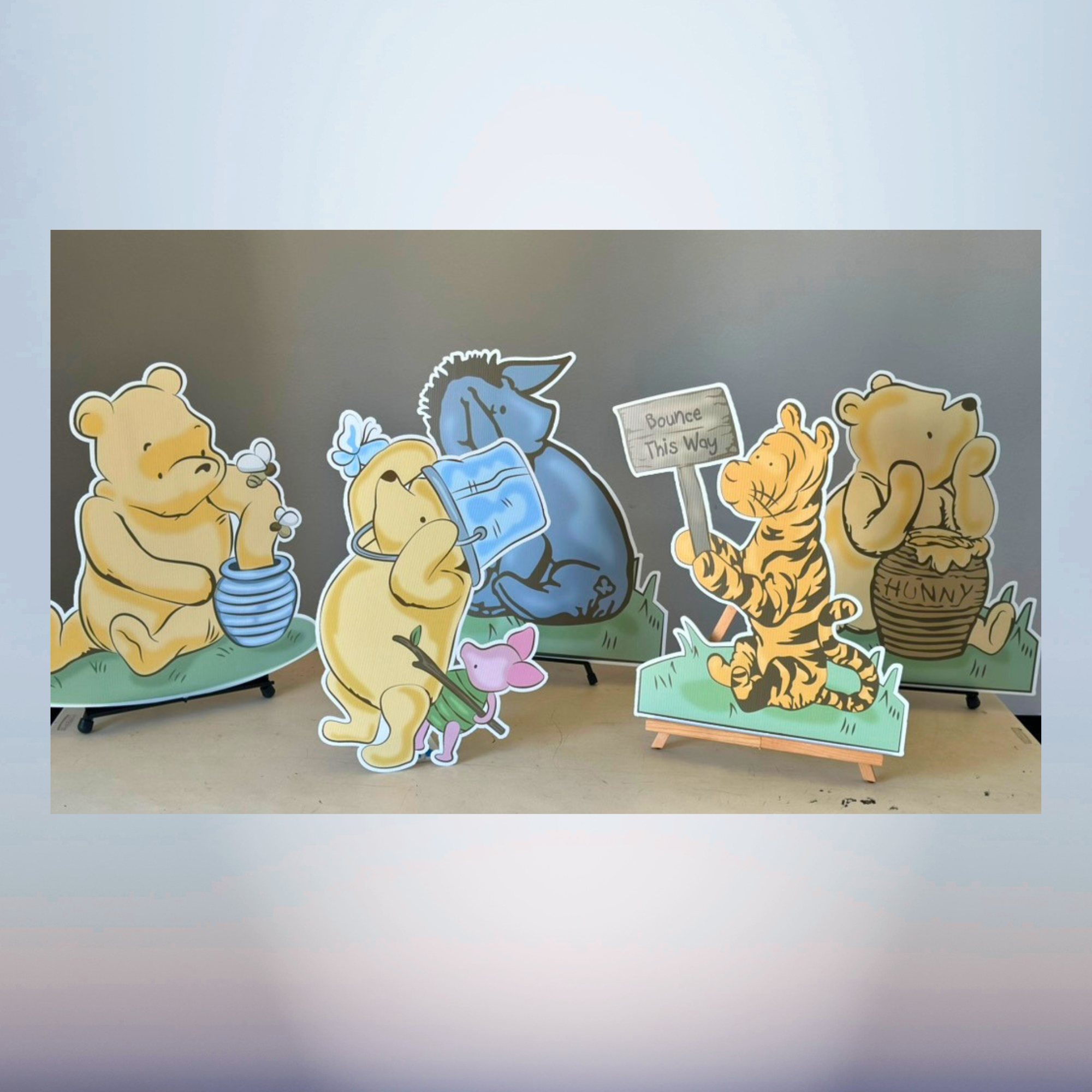Winnie the Pooh themed baby shower character cutout collection with honey scenes