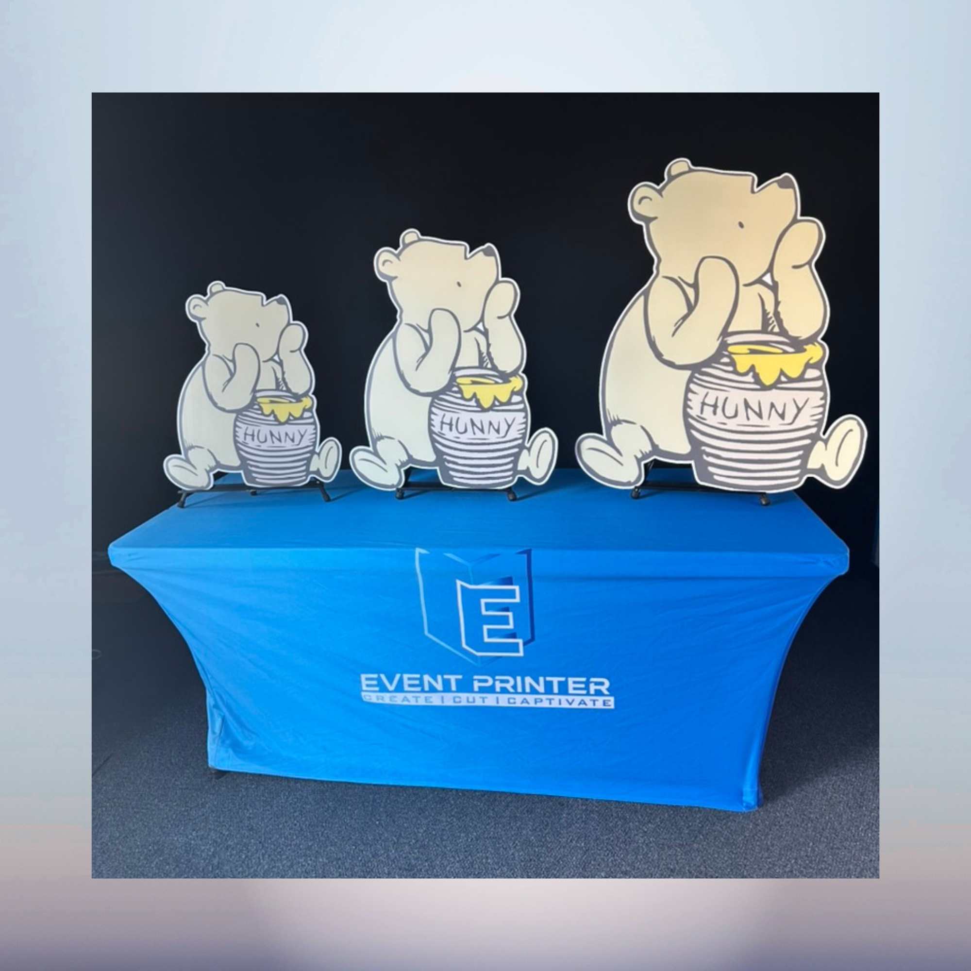 Winnie the Pooh standing with honey pot character cutout for a baby shower