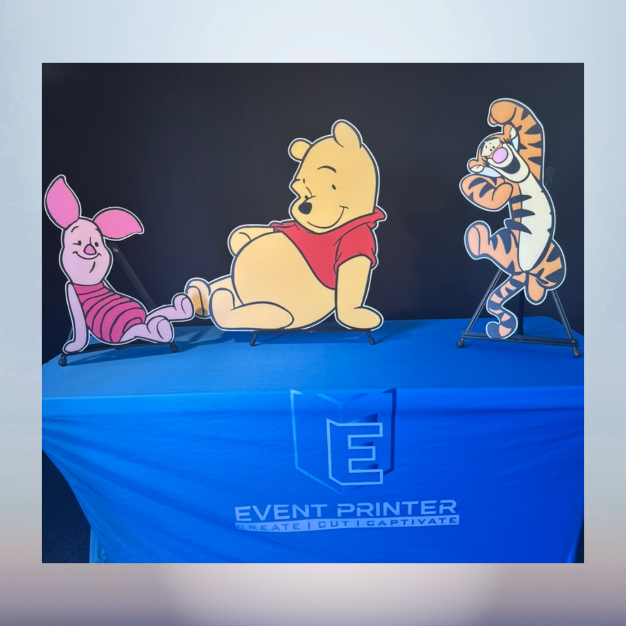 Winnie the Pooh Piglet and Tigger character cutouts displayed together for a baby shower