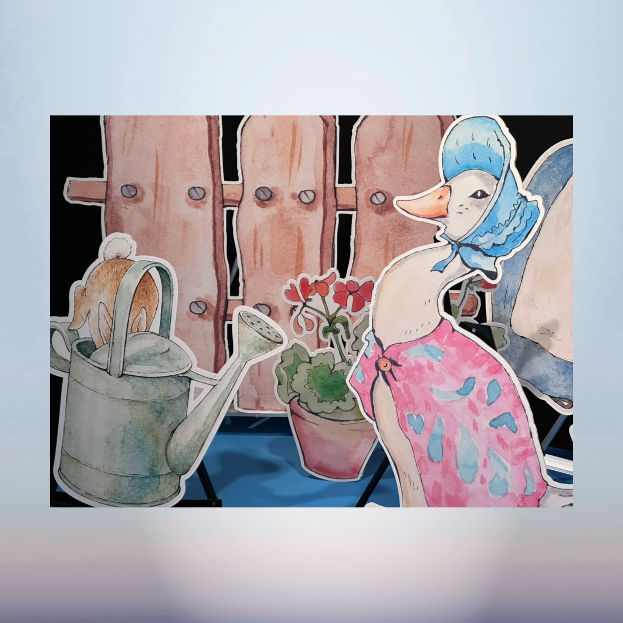 Watercolor storybook duck character cutout with garden flowers for a baby shower