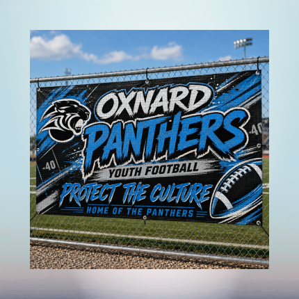 Custom wind-resistant vinyl mesh sports banner attached to a chain-link football field fence.
